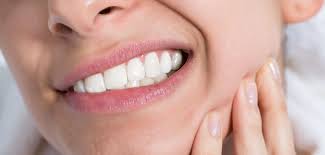 A dentist applying dental bonding to support bruxism cracks treatment with overlay restorations.